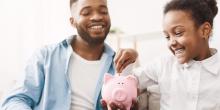 Kid putting money in piggy bank